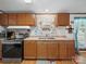 Functional kitchen with wooden cabinets, stainless steel appliances, and durable laminate countertops at 130 Benton Rd, Kings Mountain, NC 28086