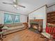 Spacious living room with wood flooring, a stone fireplace, and a comfortable sofa for relaxation at 130 Benton Rd, Kings Mountain, NC 28086