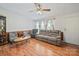 Cozy living room featuring wood-look flooring, ceiling fan, ample natural light, and comfortable seating at 130 Benton Rd, Kings Mountain, NC 28086