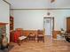 Cozy living room with wood floors, wood-paneled walls, and decorative fireplace with hearth and built-in shelves at 130 Benton Rd, Kings Mountain, NC 28086