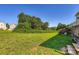 A sprawling backyard with a small wooden deck and verdant green grass at 130 Ridge Bluff Rd, Mooresville, NC 28115