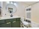 Bathroom featuring an olive-colored vanity, modern faucet, and striped shower curtain at 130 Ridge Bluff Rd, Mooresville, NC 28115
