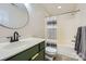 Bathroom featuring an olive-colored vanity, modern faucet, and striped shower curtain at 130 Ridge Bluff Rd, Mooresville, NC 28115