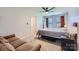 A cozy bedroom with carpet, natural light, large mirror and comfy couch at 130 Ridge Bluff Rd, Mooresville, NC 28115
