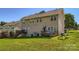 Exterior view of the back of a home with a deck and expansive, grassy backyard at 130 Ridge Bluff Rd, Mooresville, NC 28115