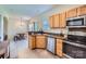 Functional kitchen featuring stainless steel appliances, wooden cabinetry, and an open layout to the dining area at 130 Ridge Bluff Rd, Mooresville, NC 28115