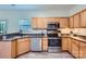 Efficient kitchen featuring stainless steel appliances, wooden cabinetry, and modern countertops at 130 Ridge Bluff Rd, Mooresville, NC 28115
