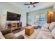 Inviting living room featuring hardwood floors, a ceiling fan, a large window, and comfortable furnishings at 130 Ridge Bluff Rd, Mooresville, NC 28115