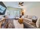 Bright and airy living room featuring hardwood floors, a ceiling fan, and comfortable furnishings at 130 Ridge Bluff Rd, Mooresville, NC 28115