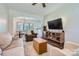 Cozy living room with comfortable seating, a ceiling fan, stylish decor and an open layout to the dining area at 130 Ridge Bluff Rd, Mooresville, NC 28115