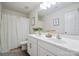 Bright bathroom featuring double vanity sinks, framed mirror and patterned shower curtain at 154 King William Dr, Mooresville, NC 28115