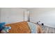 Cozy bedroom featuring hardwood floors, stuffed animals, and natural light from the window at 154 King William Dr, Mooresville, NC 28115