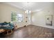 Bright dining room with a view to the front, hardwood floors, and modern chandelier at 154 King William Dr, Mooresville, NC 28115