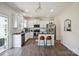 Modern kitchen with white cabinetry, stainless steel appliances, granite countertops, and a breakfast bar at 154 King William Dr, Mooresville, NC 28115