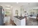 Open kitchen with stainless steel appliances, island with seating, and hardwood floors at 154 King William Dr, Mooresville, NC 28115
