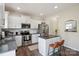 Well-lit kitchen with white cabinets, stainless steel appliances, granite countertops and a breakfast bar at 154 King William Dr, Mooresville, NC 28115