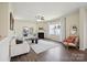 Bright living room with fireplace, modern decor, hardwood floors and lots of natural light at 154 King William Dr, Mooresville, NC 28115