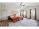 Bright main bedroom with ceiling fan, textured rug, and decorative macrame wall art at 154 King William Dr, Mooresville, NC 28115