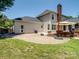 Paver patio with grill, a shade umbrella, and view of the home's exterior and backyard at 165 Cottontail Se Ln, Concord, NC 28025
