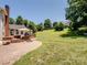 The backyard features a paved patio area with a grill, green lawn, and mature trees at 165 Cottontail Se Ln, Concord, NC 28025