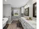 Elegant bathroom featuring a soaking tub, walk-in shower, and double vanity sinks at 165 Cottontail Se Ln, Concord, NC 28025