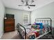 Cozy bedroom featuring a ceiling fan, window, and a bed with comic book themed bedding at 165 Cottontail Se Ln, Concord, NC 28025