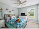 Charming bedroom showcasing a ceiling fan, window, and bed with patterned bedding at 165 Cottontail Se Ln, Concord, NC 28025