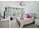 Bright bedroom with a window, ceiling fan, and a bed with pink and white checkered bedding at 165 Cottontail Se Ln, Concord, NC 28025