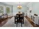 Light-filled dining room with modern lighting, large windows, and neutral color palette at 165 Cottontail Se Ln, Concord, NC 28025
