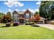 Beautiful two-story brick home with stone accents, mature landscaping, and an attached two-car garage at 165 Cottontail Se Ln, Concord, NC 28025