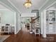 Inviting hallway with hardwood floors, white trim, and views into other rooms at 165 Cottontail Se Ln, Concord, NC 28025