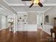 Open-concept living area featuring a fireplace, hardwood floors, and built-in shelving at 165 Cottontail Se Ln, Concord, NC 28025