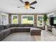Cozy living room with stone accent wall, neutral decor, and abundant natural light at 165 Cottontail Se Ln, Concord, NC 28025