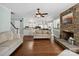 Open-concept living room and kitchen with stone fireplace, hardwood floors and modern appliances at 165 Cottontail Se Ln, Concord, NC 28025