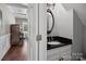 Stylish powder room with dark wood floors, decorative mirror, and elegant vanity at 165 Cottontail Se Ln, Concord, NC 28025