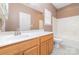 Bathroom with wood vanity, tub-shower, and updated fixtures at 168 Devon Forest Dr, Mooresville, NC 28115