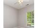 A bright bedroom with a window offering pleasant outdoor views and neutral colored walls at 168 Devon Forest Dr, Mooresville, NC 28115