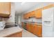 Functional kitchen with wooden cabinets, stainless steel appliances, and neutral countertops at 168 Devon Forest Dr, Mooresville, NC 28115