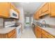 Efficient kitchen featuring wood cabinets, laminate countertops, and white appliances at 168 Devon Forest Dr, Mooresville, NC 28115
