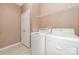 A practical laundry room with washer, dryer, and storage shelves for convenience at 168 Devon Forest Dr, Mooresville, NC 28115