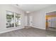 Bright living room featuring stylish gray floors, ample natural light, and a view of the kitchen at 168 Devon Forest Dr, Mooresville, NC 28115