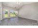 Bright living room featuring stylish flooring, large windows, and a glass paneled exterior door at 168 Devon Forest Dr, Mooresville, NC 28115
