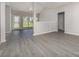 Spacious living room featuring a vaulted ceiling, a large window, and modern light gray flooring at 168 Devon Forest Dr, Mooresville, NC 28115