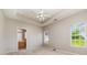 A spacious main bedroom with tray ceiling, carpet and two windows that offer pleasant outdoor views at 168 Devon Forest Dr, Mooresville, NC 28115