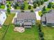 Overhead image of a well maintained home and large yard with a patio and fire pit at 17012 Alydar Commons Ln, Charlotte, NC 28278