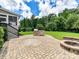 Stone paver patio featuring stone outdoor grill and fire pit at 17012 Alydar Commons Ln, Charlotte, NC 28278
