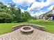 Private backyard with custom stone fire pit and landscaped lawn at 17012 Alydar Commons Ln, Charlotte, NC 28278