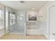 Modern bathroom with glass shower, soaking tub, and white marble tile surround at 17012 Alydar Commons Ln, Charlotte, NC 28278