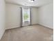 Bedroom with neutral carpet flooring, large window, and bright natural light at 17012 Alydar Commons Ln, Charlotte, NC 28278
