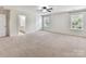 Spacious primary bedroom featuring neutral carpeting, ceiling fan, and access to ensuite bath at 17012 Alydar Commons Ln, Charlotte, NC 28278